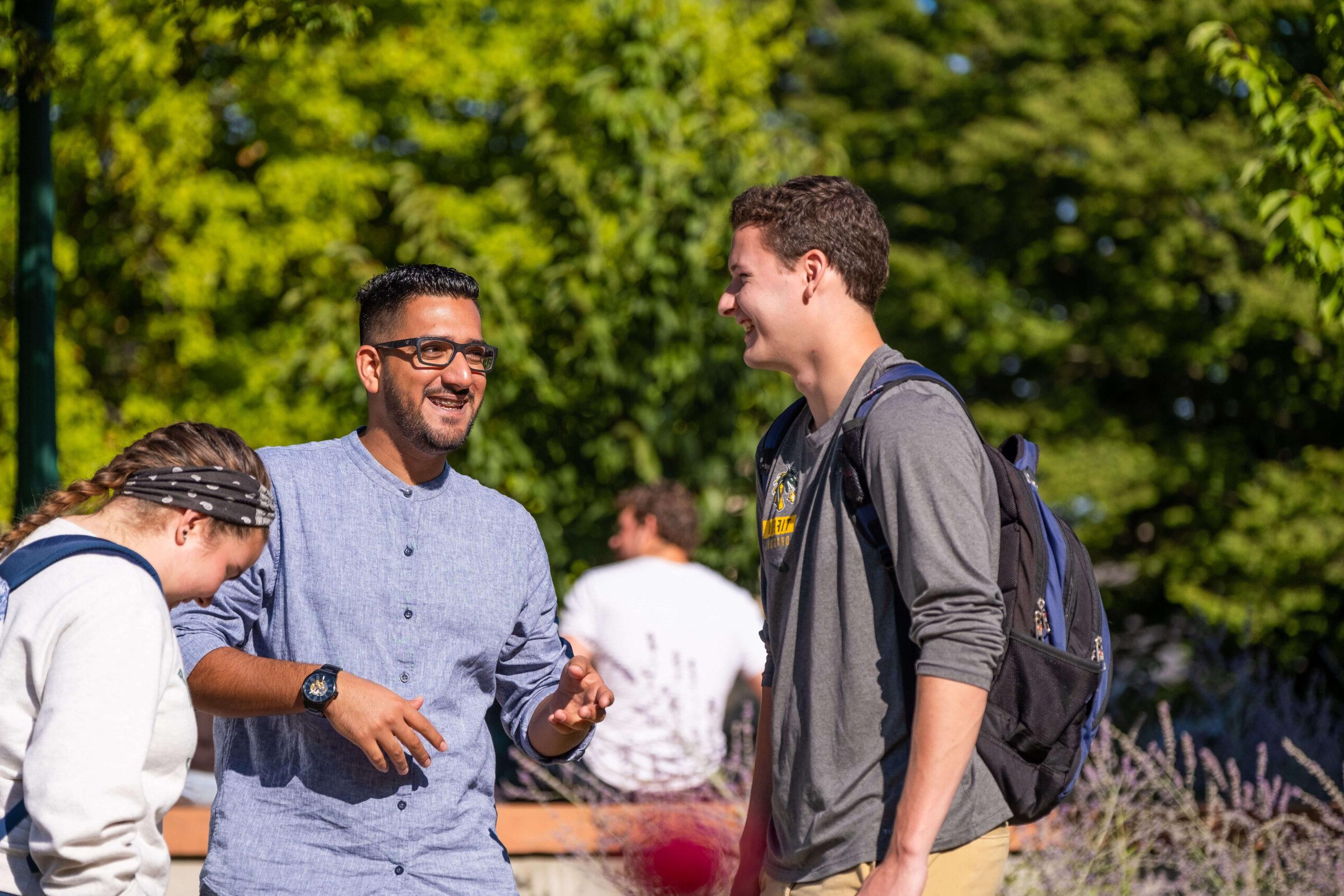 college students talking on a sunny day